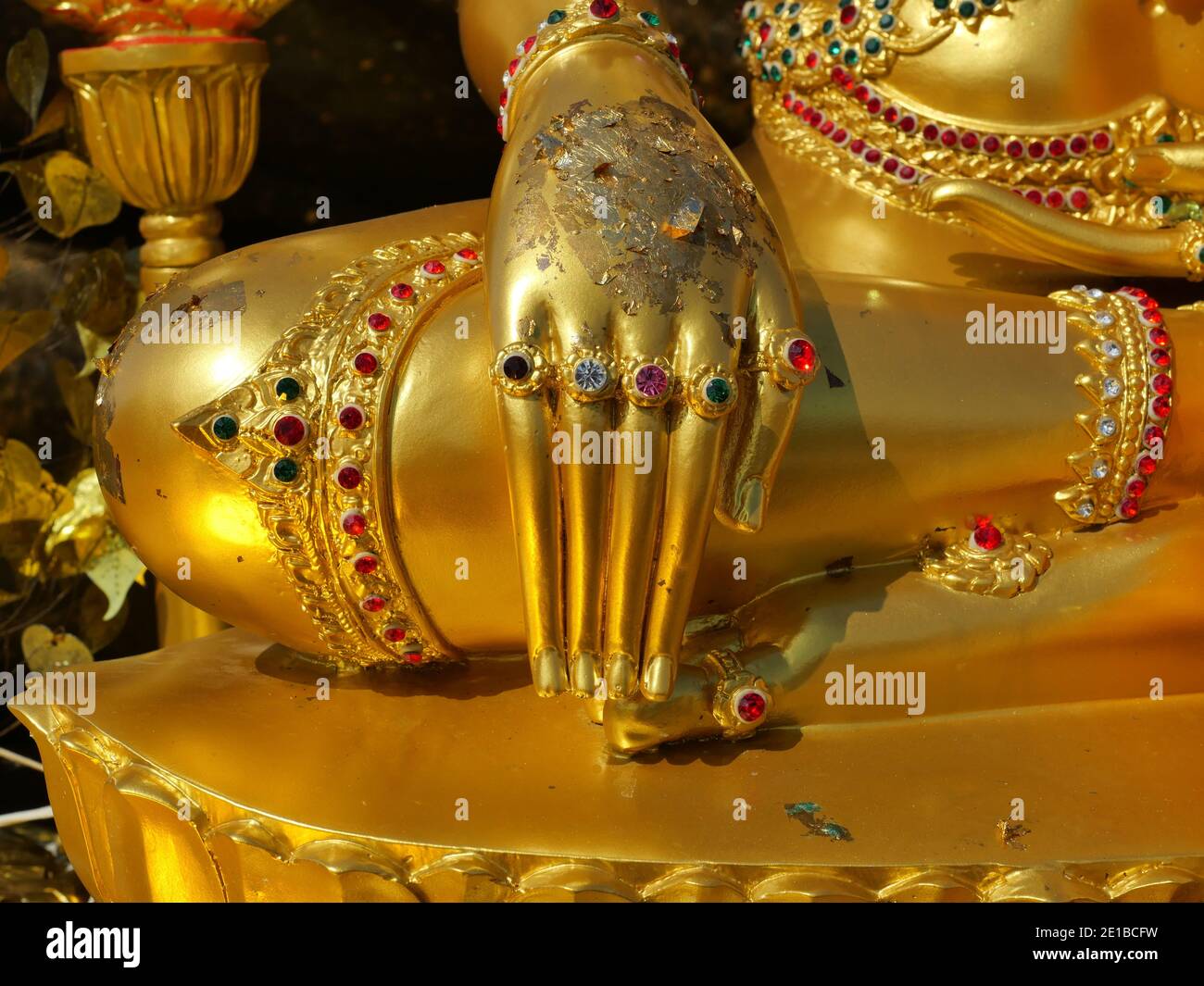 Hand on leg of The attitude of subduing Mara of golden Seated Buddha Statue, Sculpture used as amulets of Buddhism religion Stock Photo