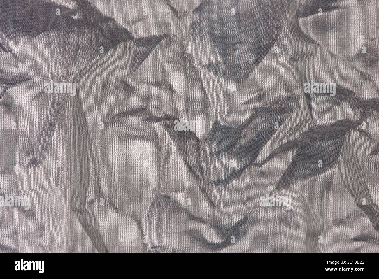 Silver crumpled fabric close up. Abstract background. Stock Photo