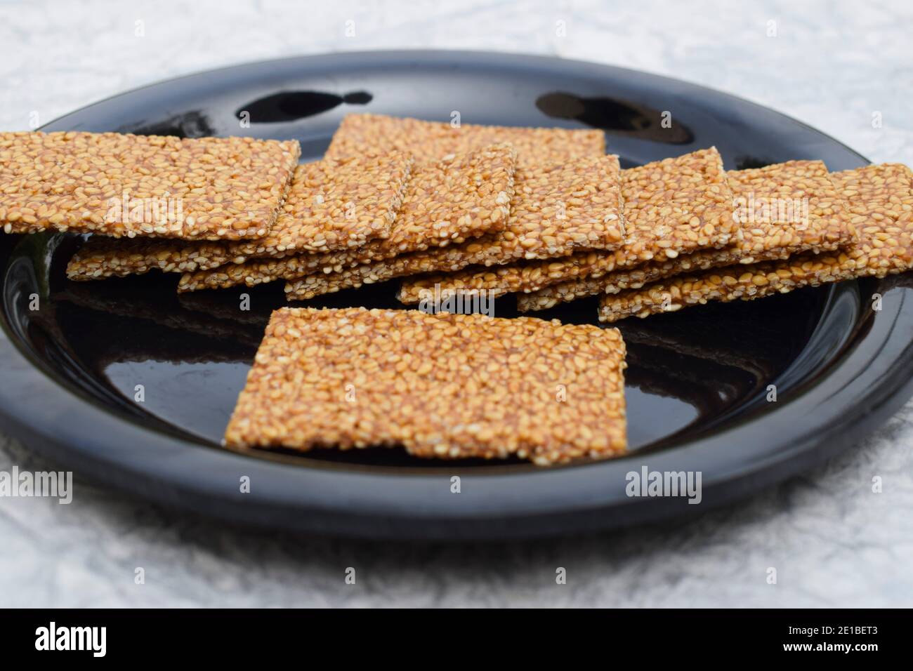 Selective focus closeup of Til sakri or Tilgul an Indian traditional popular sweet made out of Sesame seeds and jaggery. Famous Sankranti festival des Stock Photo