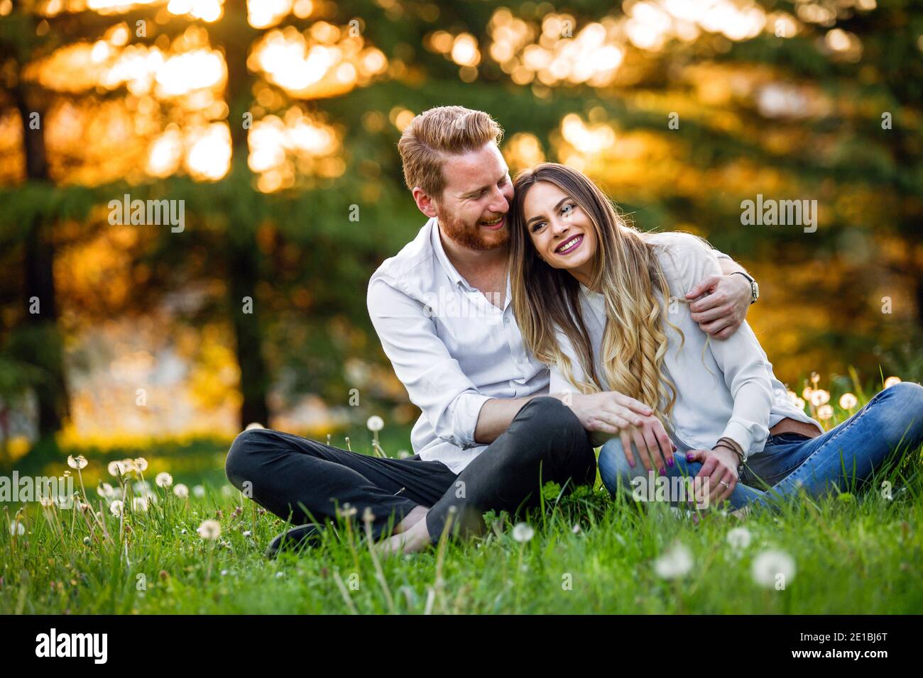 Portrait of a happy young couple enjoying a day in the park Stock Photo ...