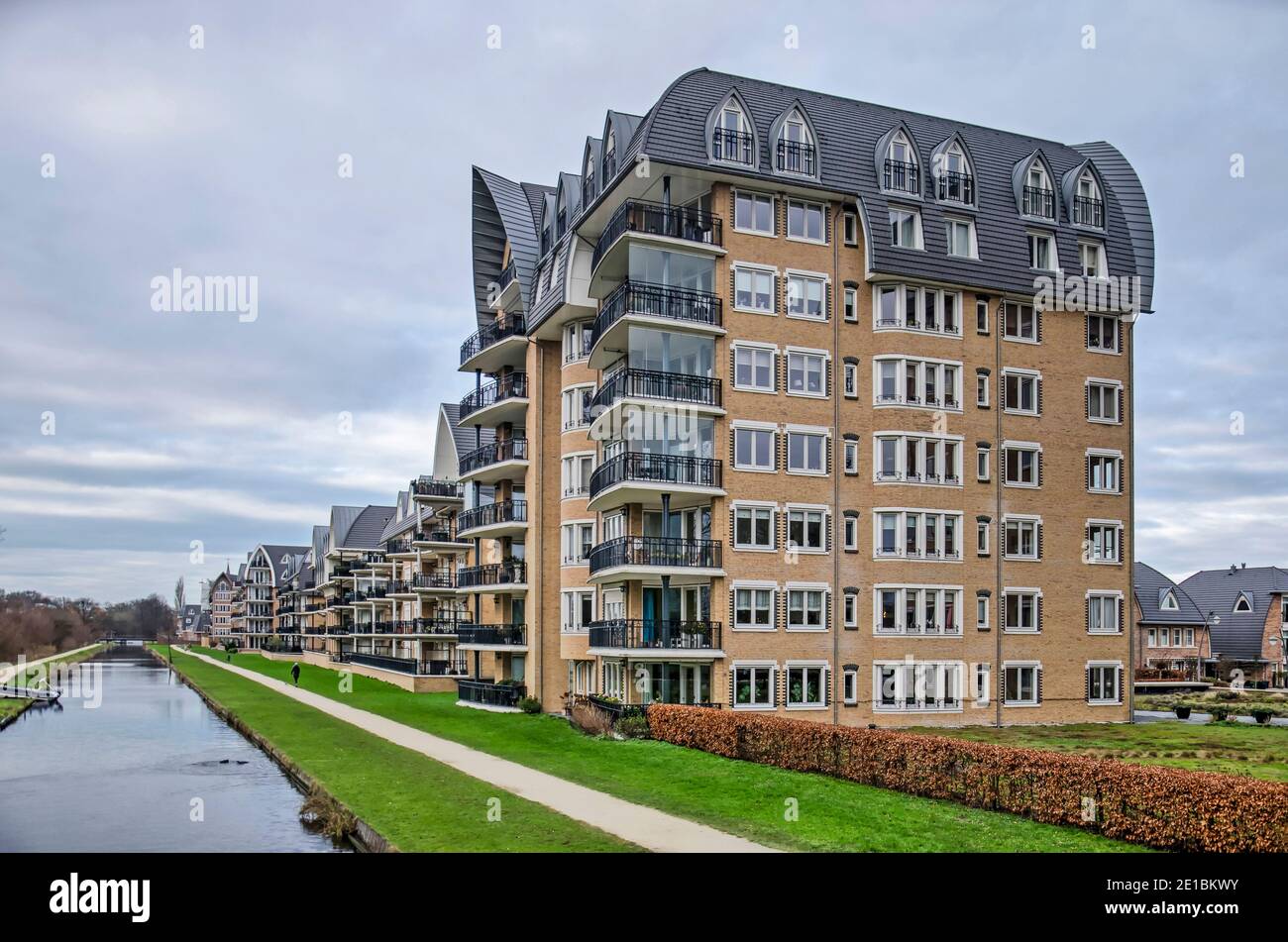 Voorschoten, The Netherlands, January 3, 2021: eight-storey residential building in Krimwijk neighbourhood with brick facades and sculptural roof in p Stock Photo