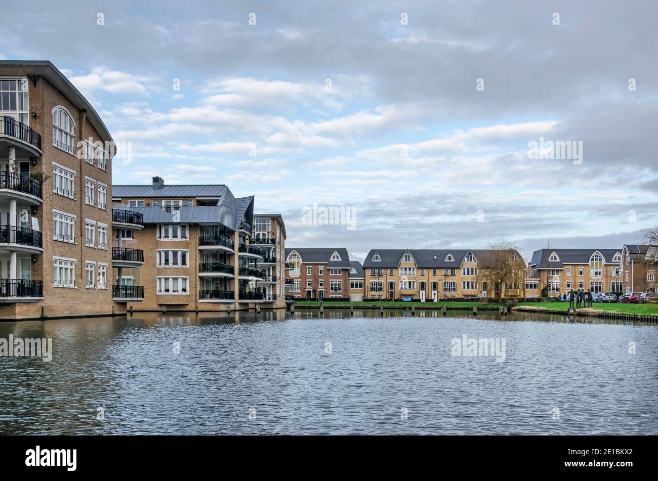 Voorschoten, The Netherlands, January 3, 2021: post-modern housing blocks around a pond in Krimwijk neighbourhood Stock Photo