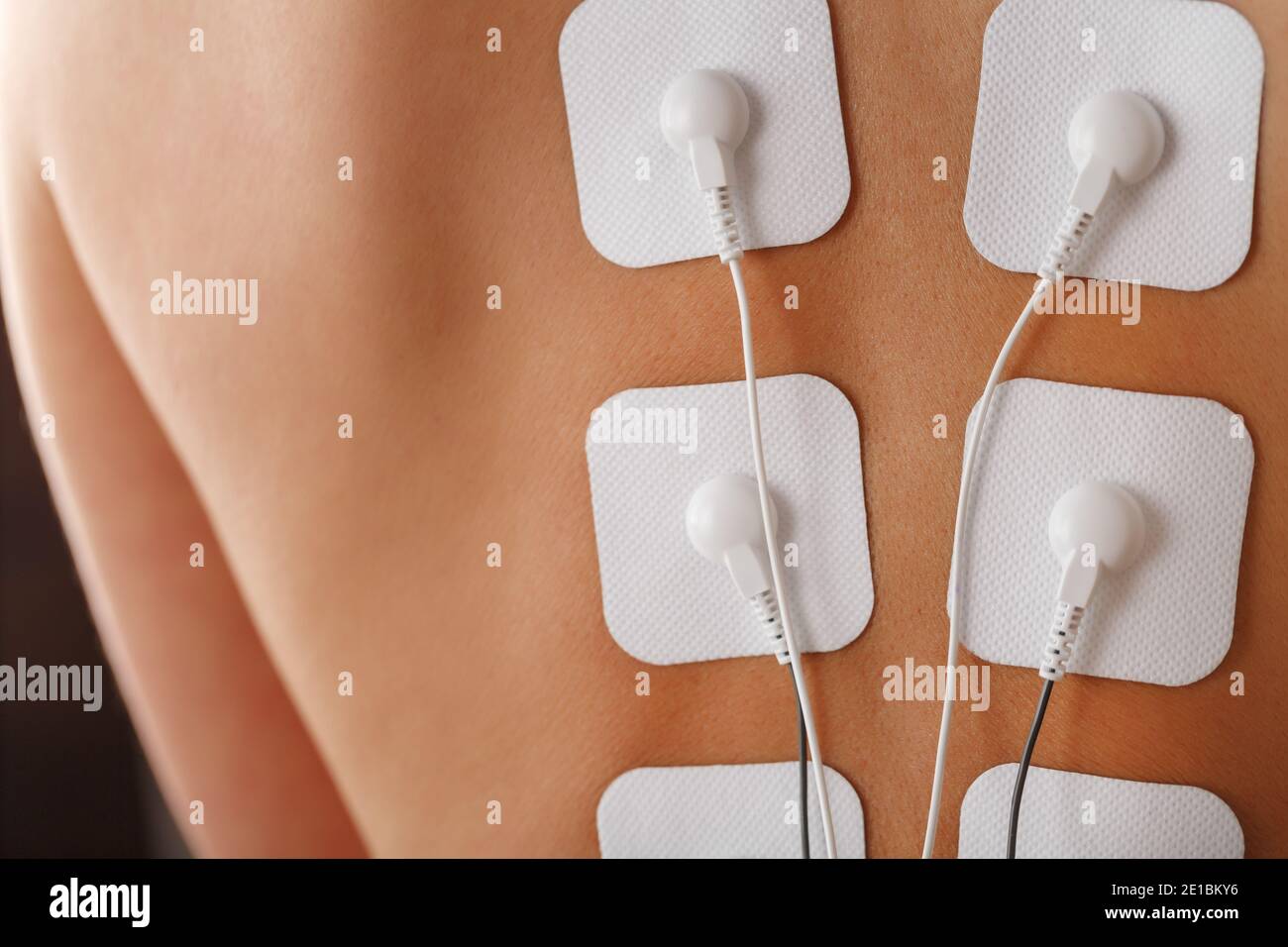 Electrical stimulation massage for lower back pain Stock Photo - Alamy