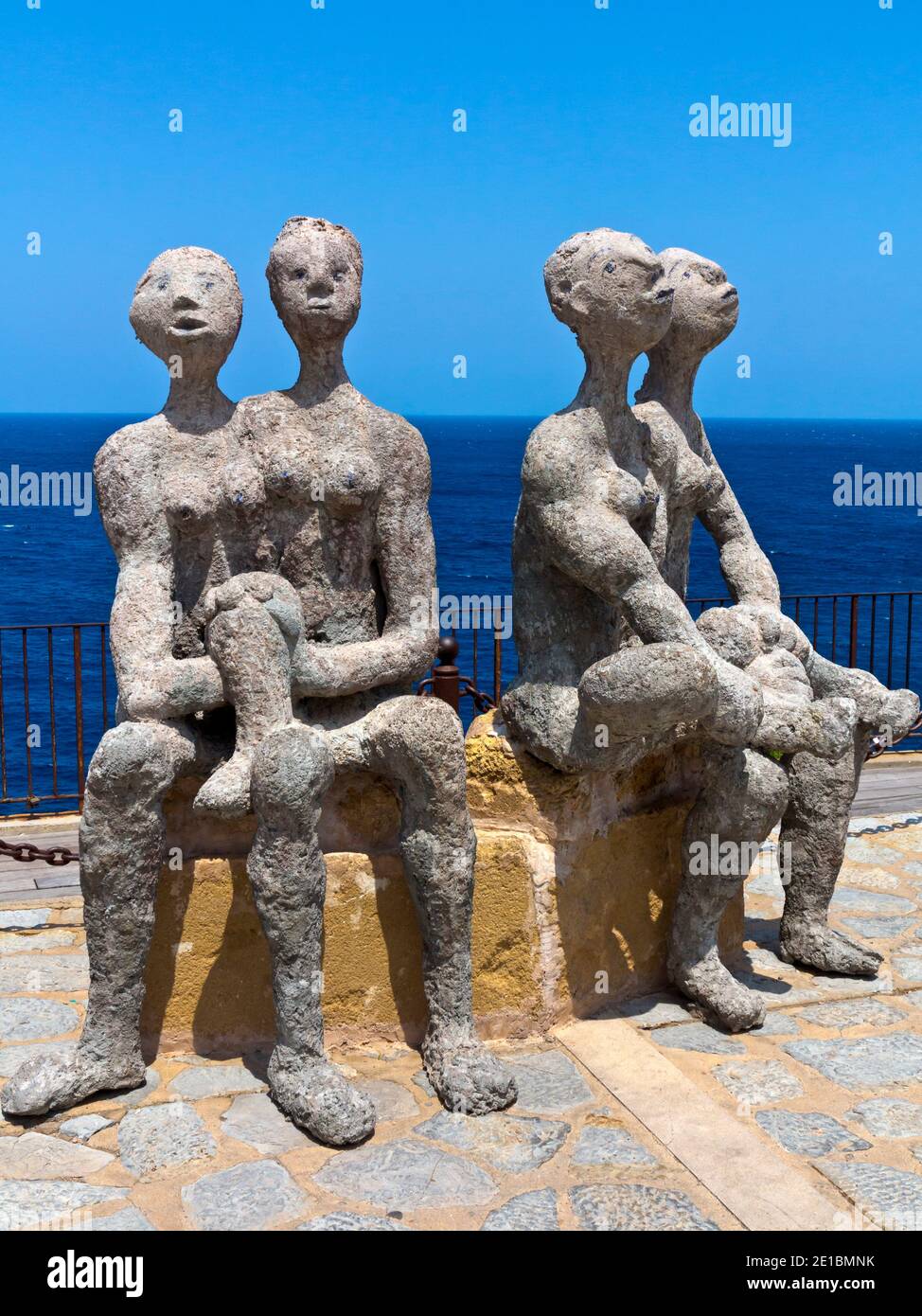 Sculptures of four figures on a cliff top at Port de Soller in Mallorca Spain Stock Photo
