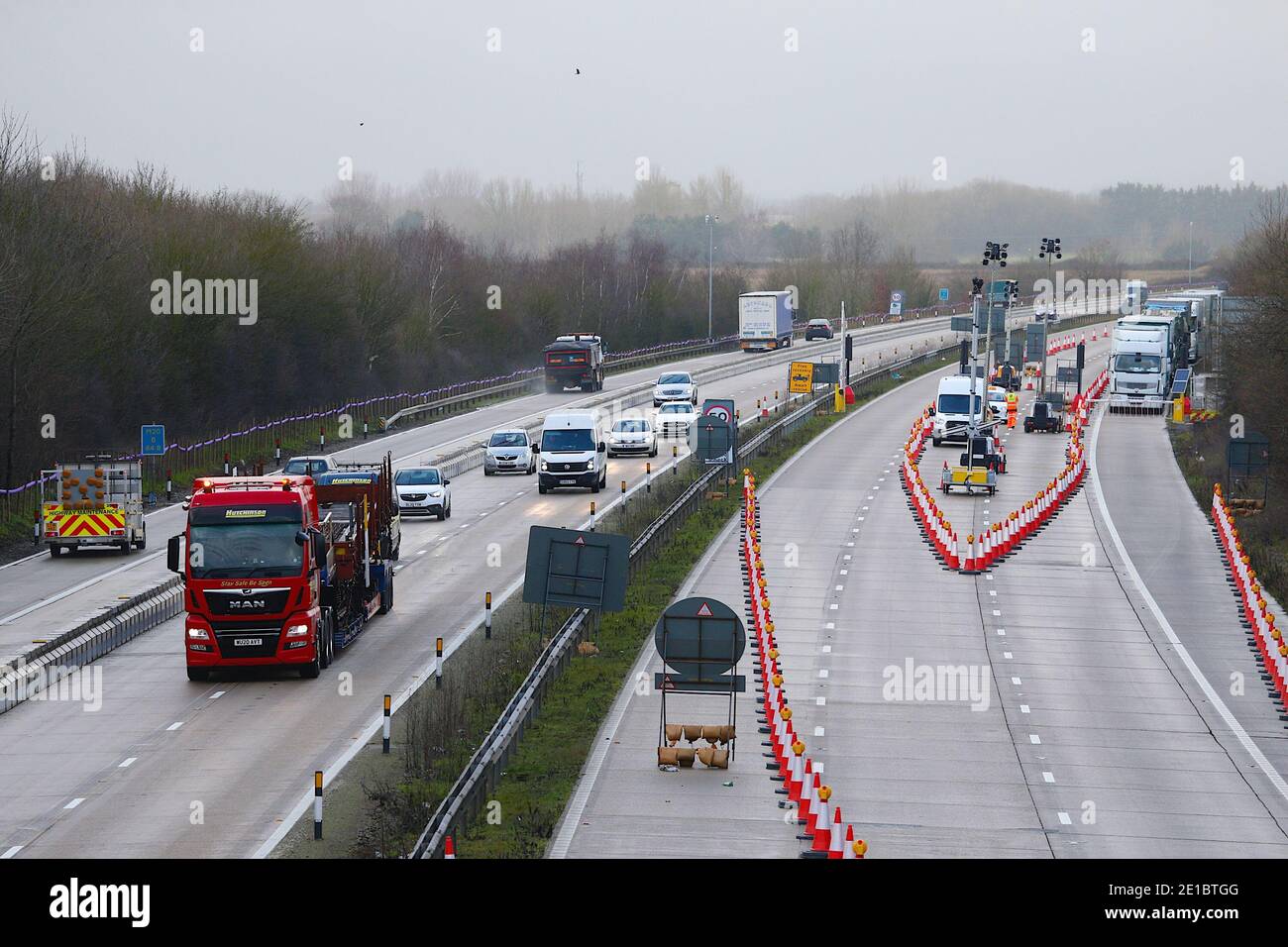 Ashford, Kent, UK. 06 January, 2021. Lorries are still queuing on the M20 between junctions 8 and 9 as Operation Brock is now in place. Moveable concrete blocks are placed on the London bound lane to allow traffic to flow in both directions. Photo Credit: PAL Media-Paul Lawrenson/Alamy Live News Stock Photo