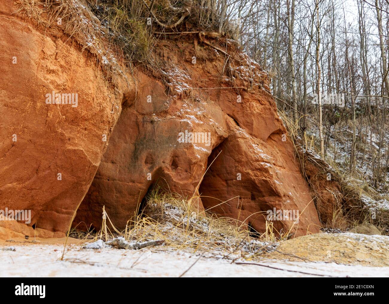 Sea cliff with Devonian sandstone outcrops. During the storm, niches and caves were washed away