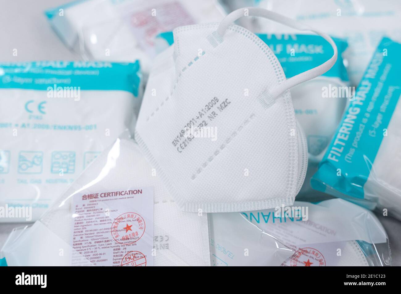 NIJMEGEN, NETHERLANDS - JANUARY 2: Unpackaged FFP2 bwetween packaged FFP2 masks. FFP2 can serve as protection against covid-19. on January 2, 2021 in Stock Photo