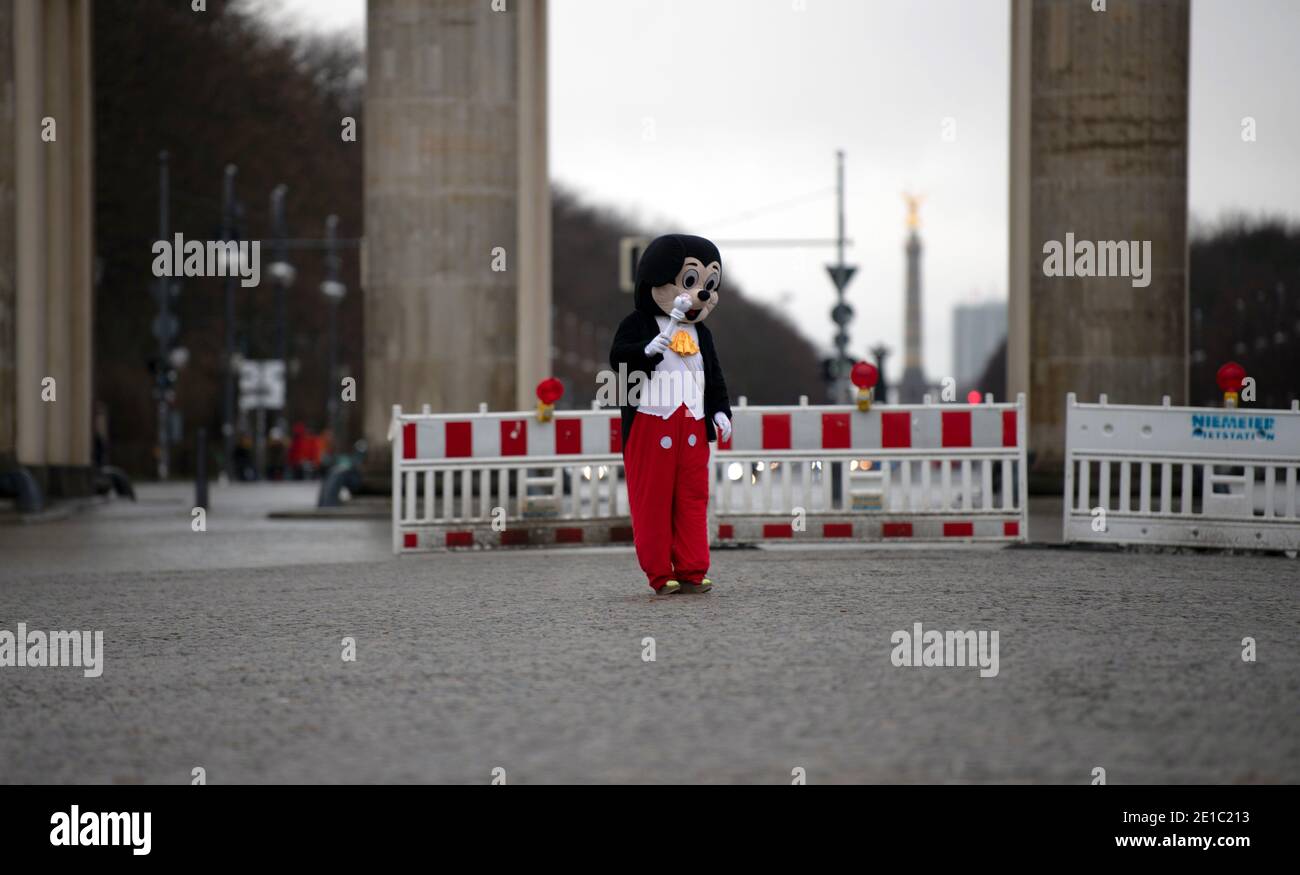 06 January 2021, Berlin: A person in a costume of the comic character