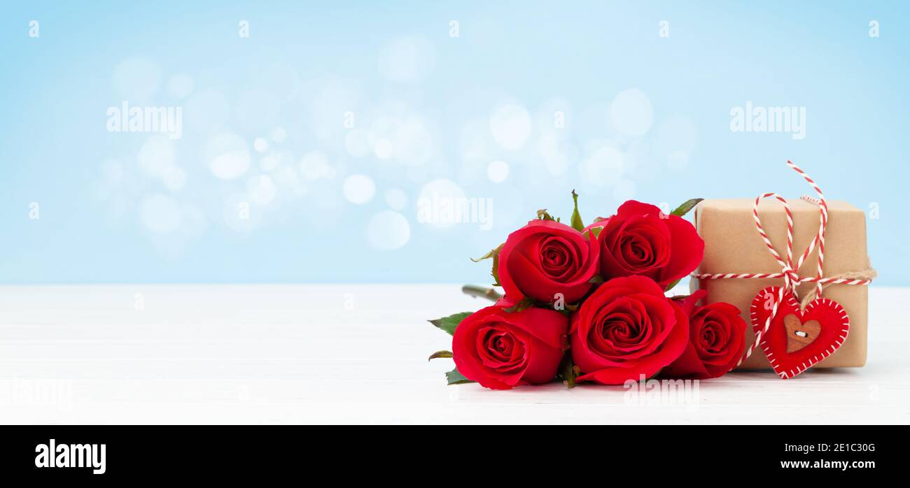 Valentines day greeting card with red rose flowers bouquet and gift box ...