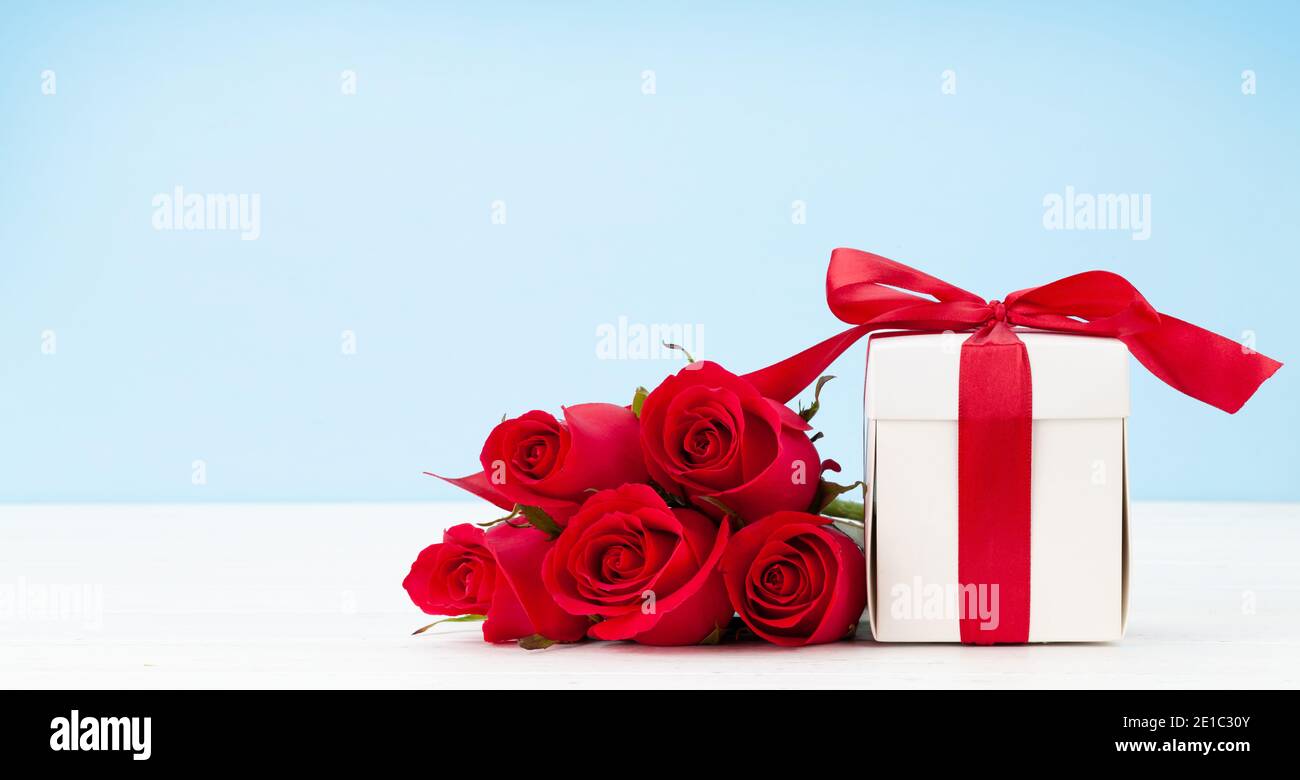 Valentines day greeting card with red rose flowers bouquet and gift box ...