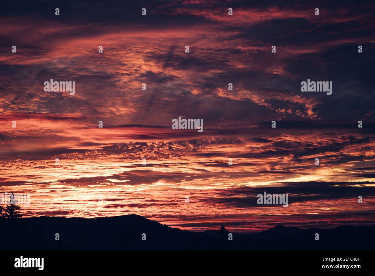 Beautiful sky at sunset. Red clouds looming over the Beskydy mountains ...