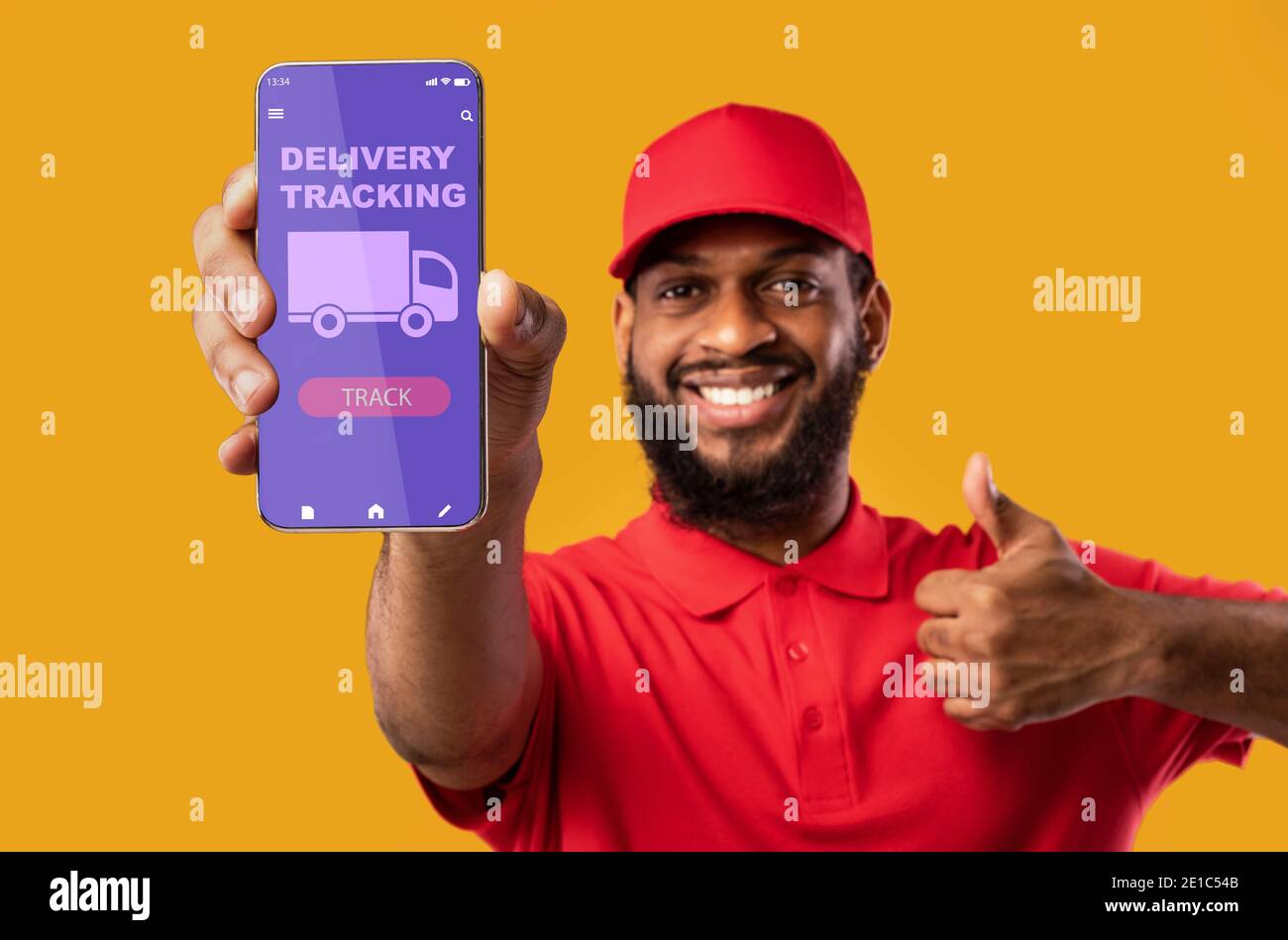Black man holding mobile phone with delivery tracking app Stock Photo