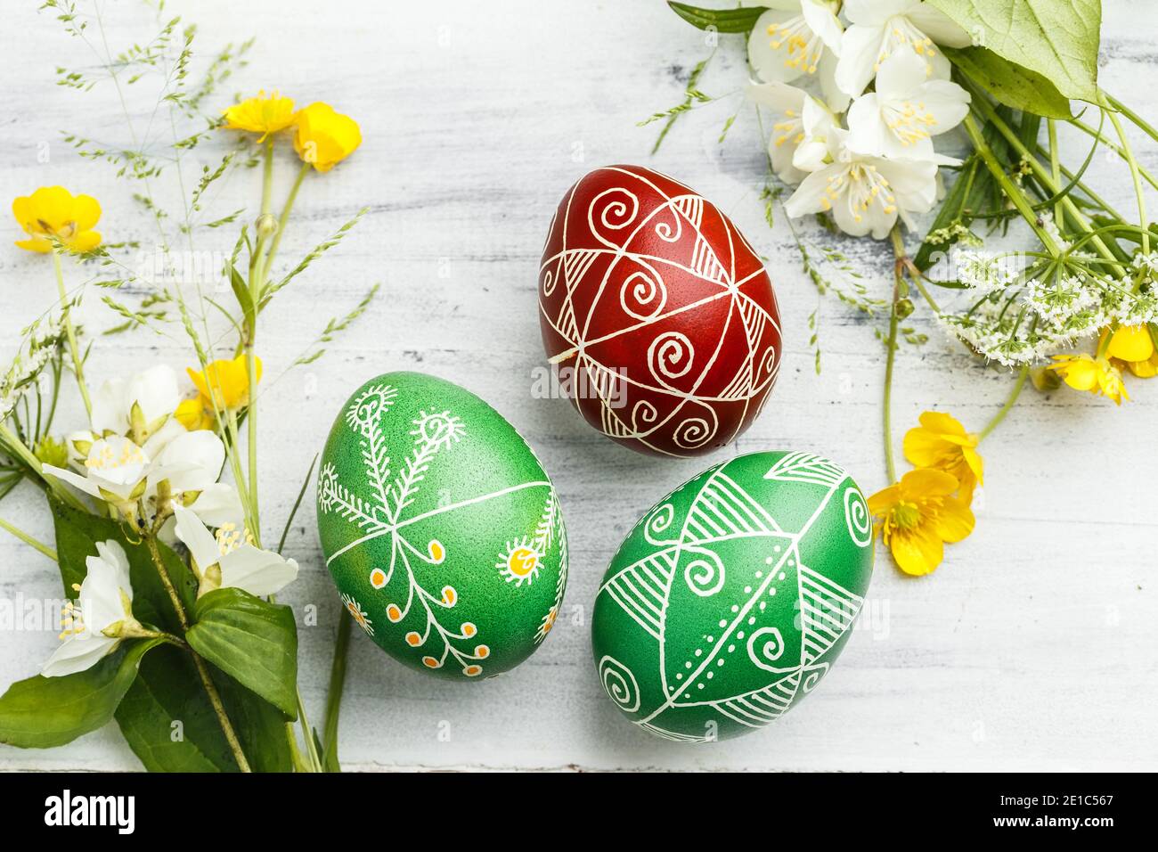 Three pysanky handmade Easter eggs. Ukrainian pysanky decorated with wax-resist dyeing technique. Holiday postcard Stock Photo