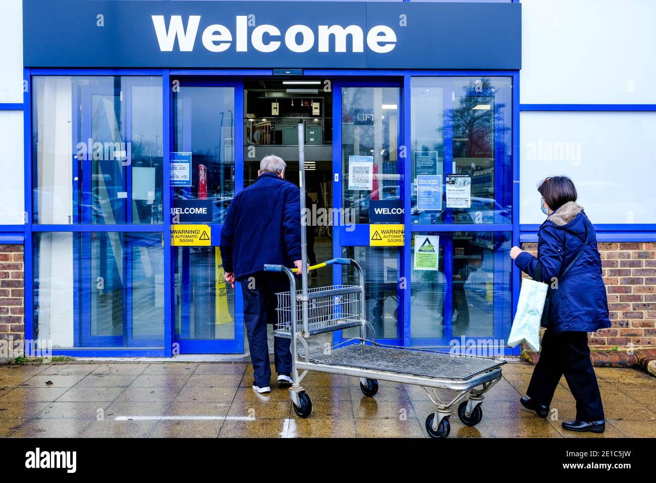 Epsom Surrey, London UK January 06 2021, Couple Entering A Wickes Home Improvement DIY Retail Outlet Stock Photo