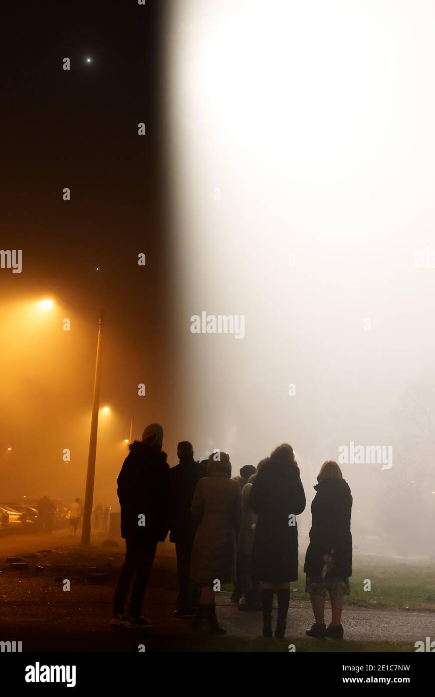 Group of people seeing UFO in the sky. Stock Photo