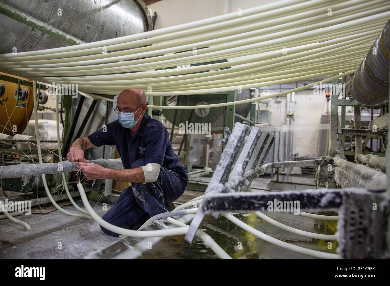 Chandler feeding lengths of candle from the ‘cotton reel drum’ onto