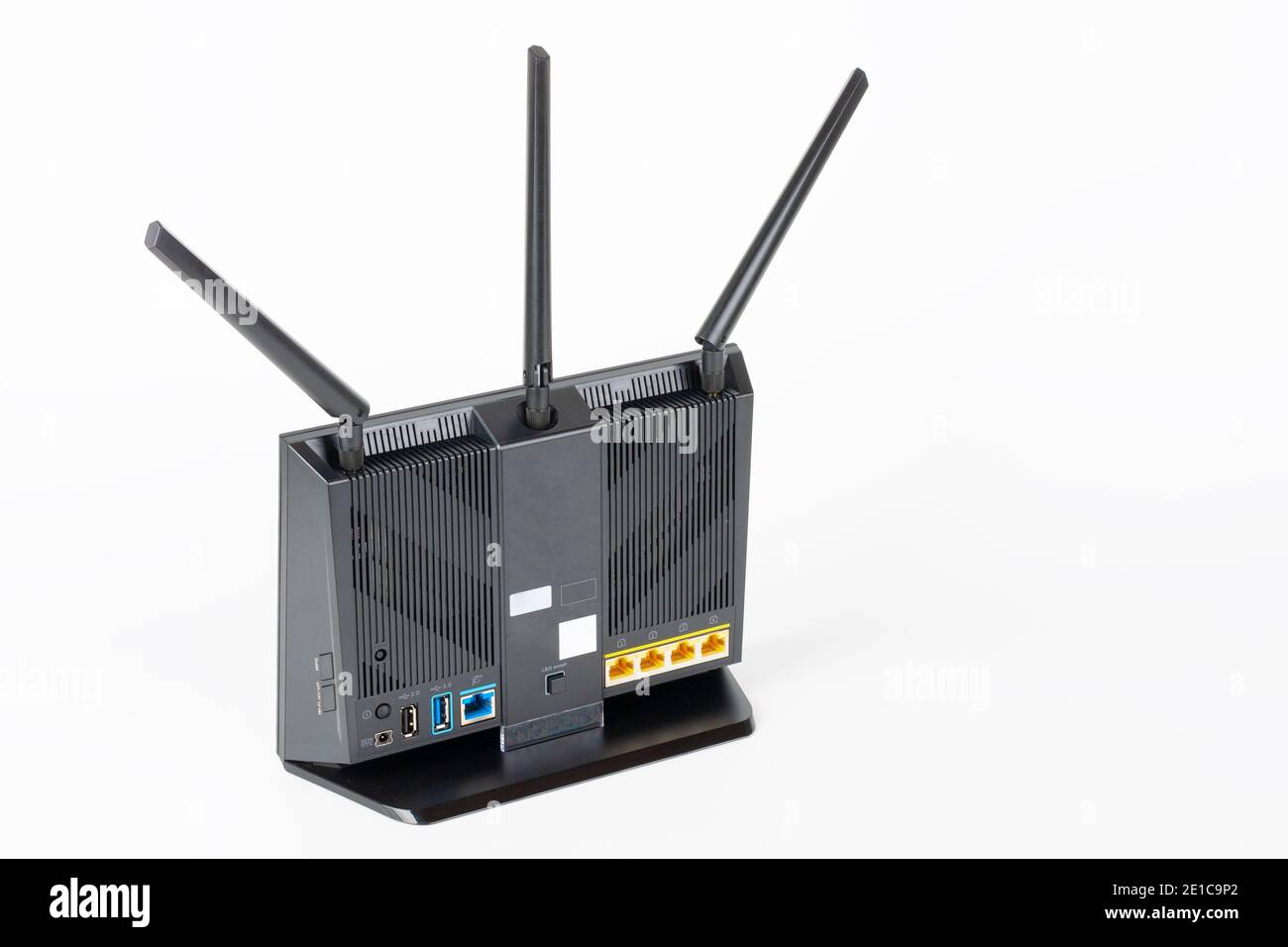 Rear view of gigabit dual-band   Wi-Fi router with  three antennas. Wireless device with five Gigabit Ethernet ports, ultrafast USB 3.1 port and  USB Stock Photo