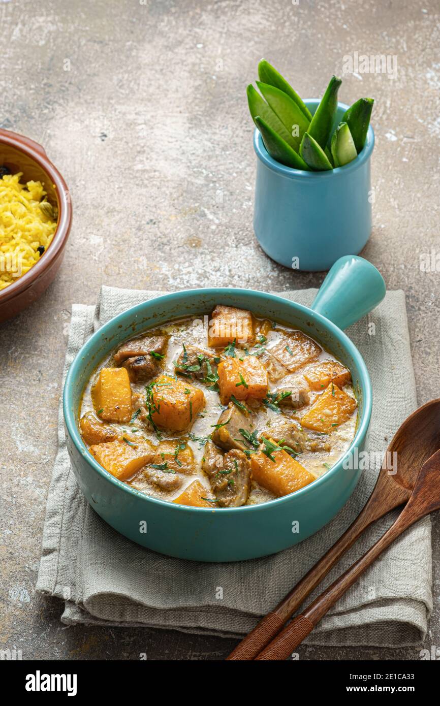 Pumpkin curry with turkey in coconut cream with rice biriani. Stock Photo