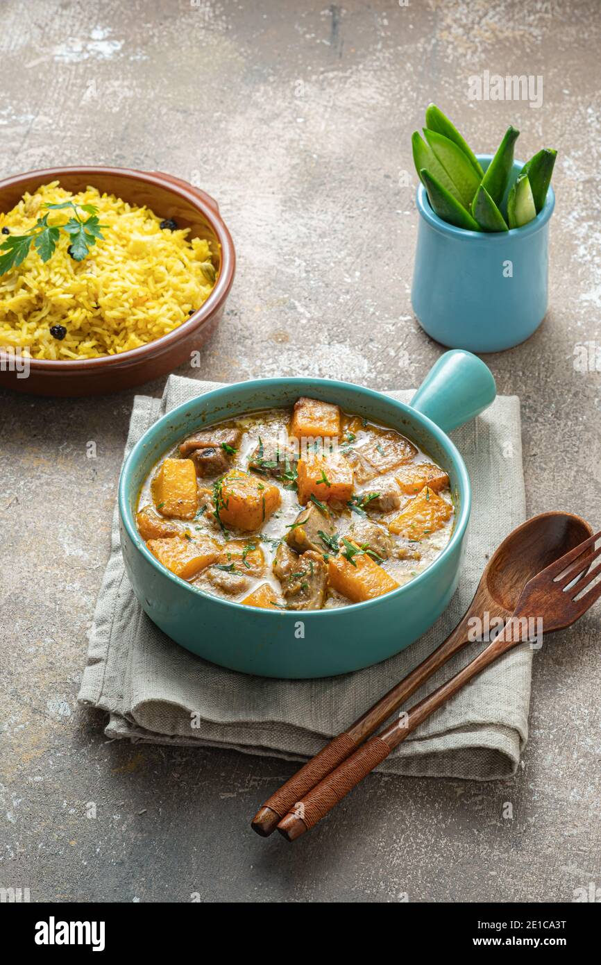 Pumpkin curry with turkey in coconut cream with rice biriani. Stock Photo