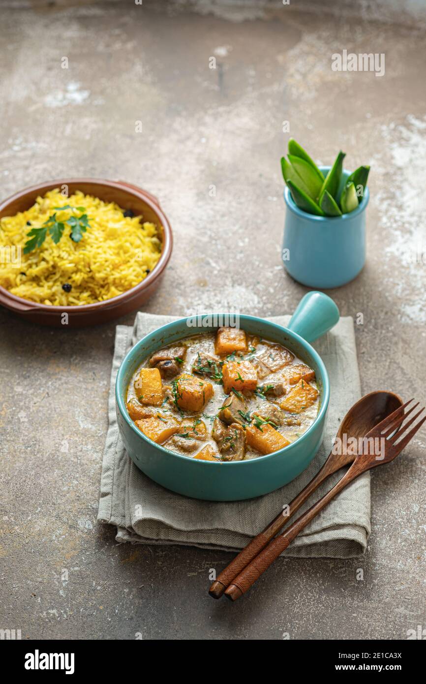 Curry with pumpkin and chicken with rice, copy space. Stock Photo