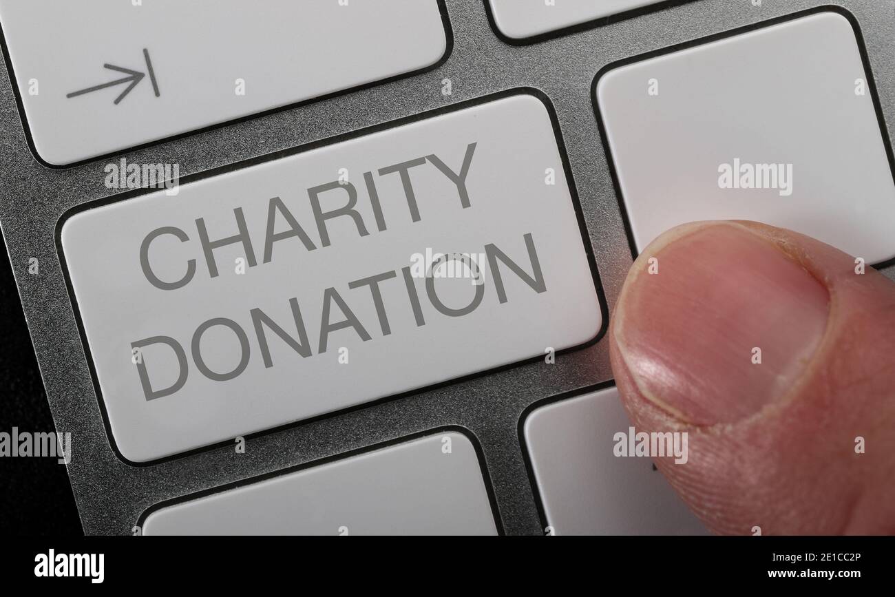 Making an online donation on a computer keyboard. Stock Photo