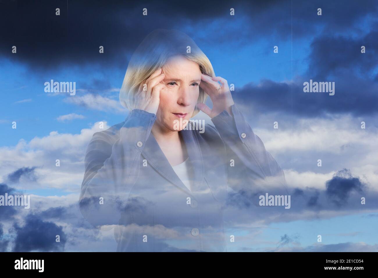 Weather sensitive woman with a headache, double exposure with dark clouds, copy space. Stock Photo