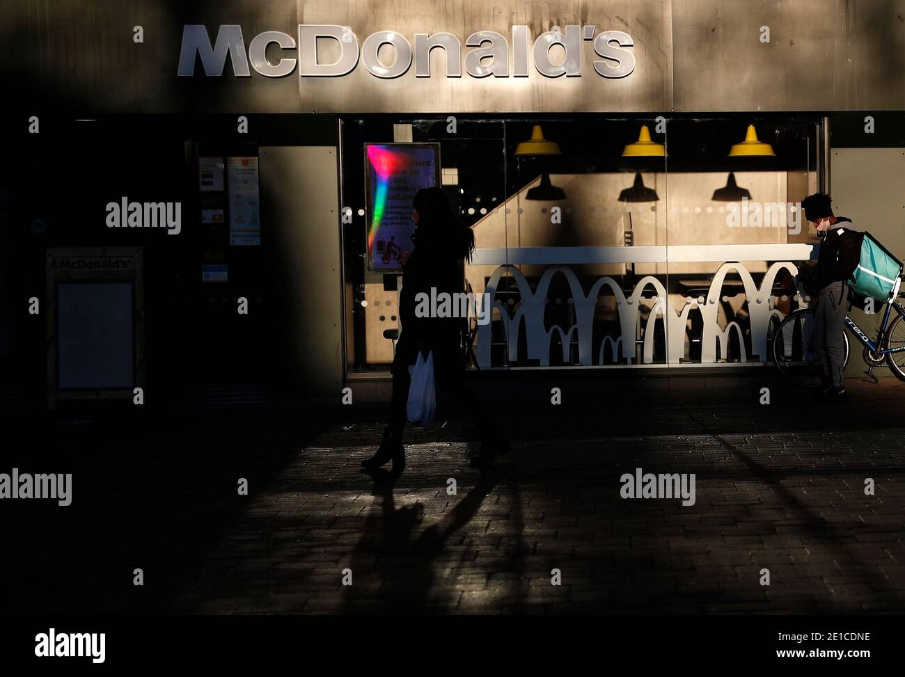 Loughborough, Leicestershire, UK. 6th January 2021. A delivery rider waits for work outside a McDonaldÕs during the third national Covid-19 lockdown. Credit Darren Staples/Alamy Live News. Stock Photo