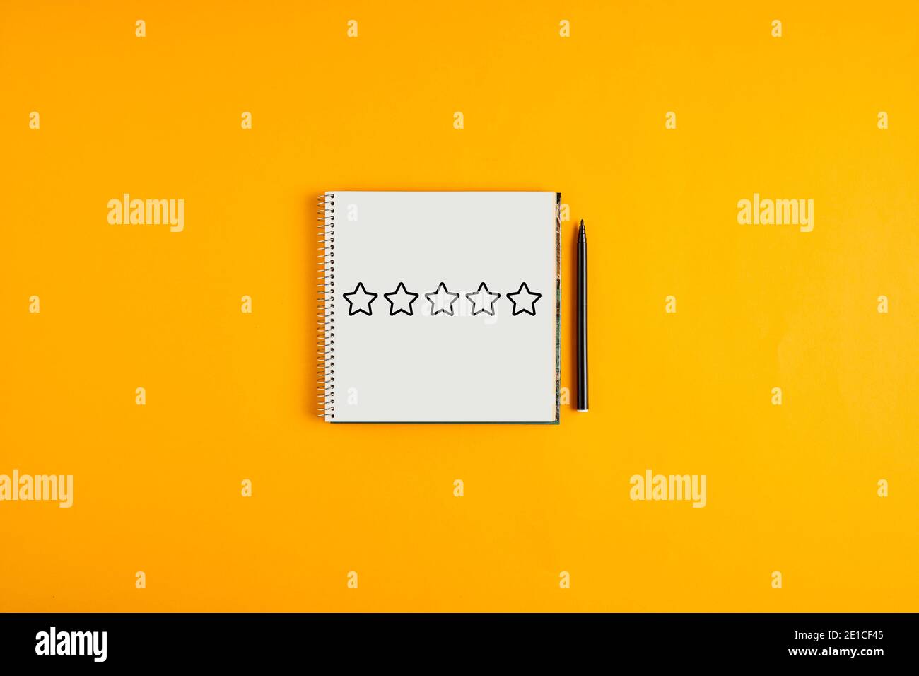 Five stars for rating or evaluation drawn on a notepad with black pen ...