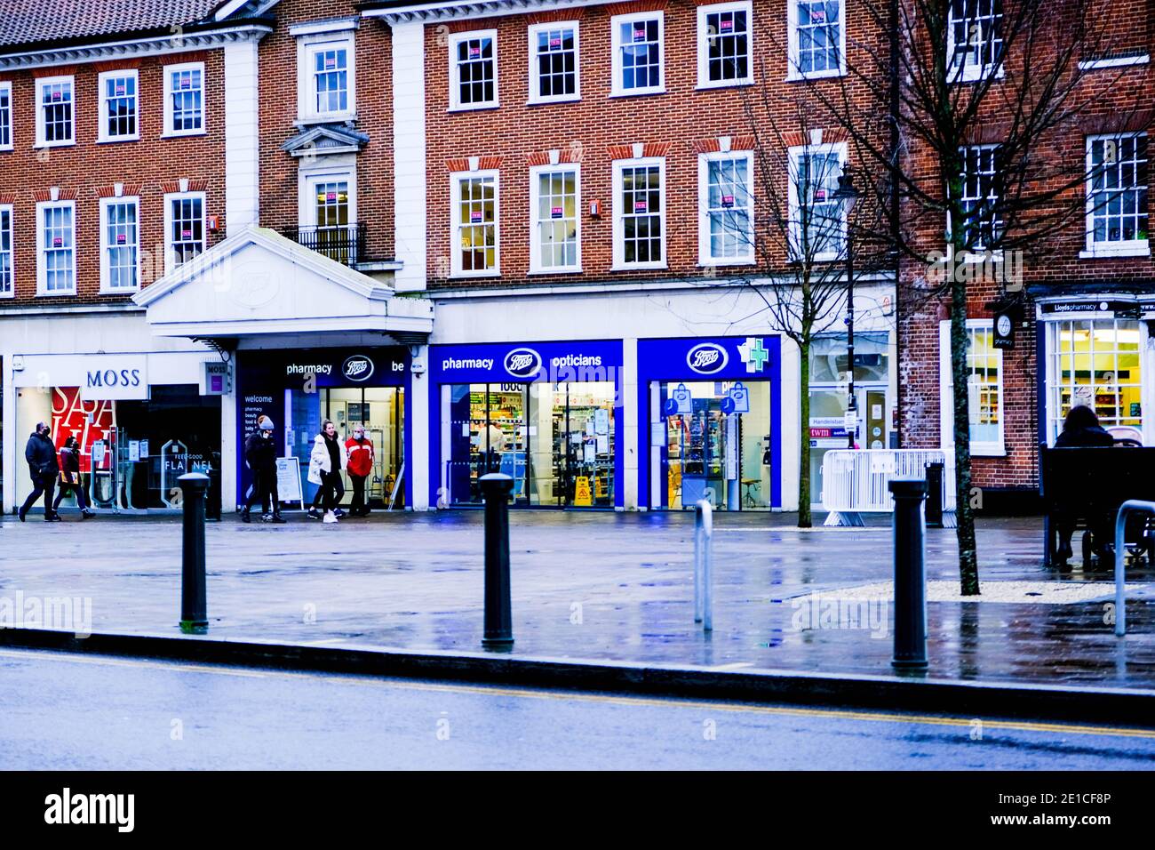 Epsom Surrey, London UK January 06 2021, Boots High Street Chemist Or Pharmacy With Small Crown Of Shoppers Ouside Stock Photo