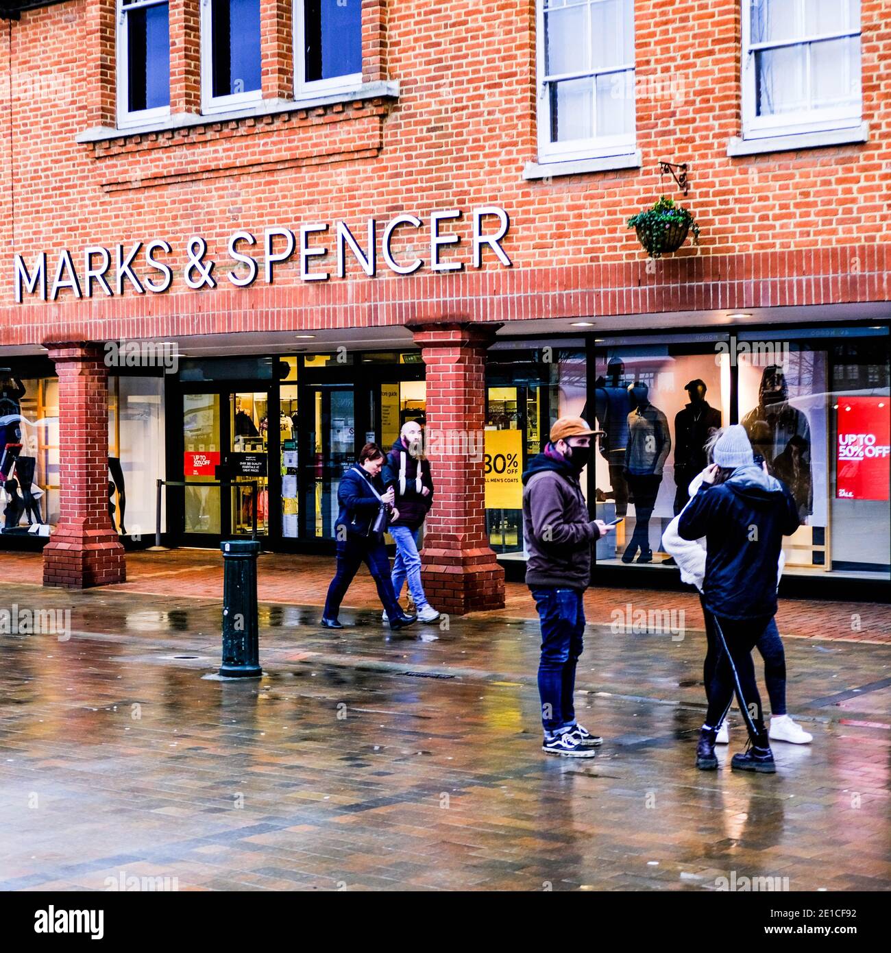 Epsom Surrey, London UK January 06 2021, Shoppers And Young People Wearing Protective Face Masks Outside Marks And Spencer High Street Retail Shop Stock Photo