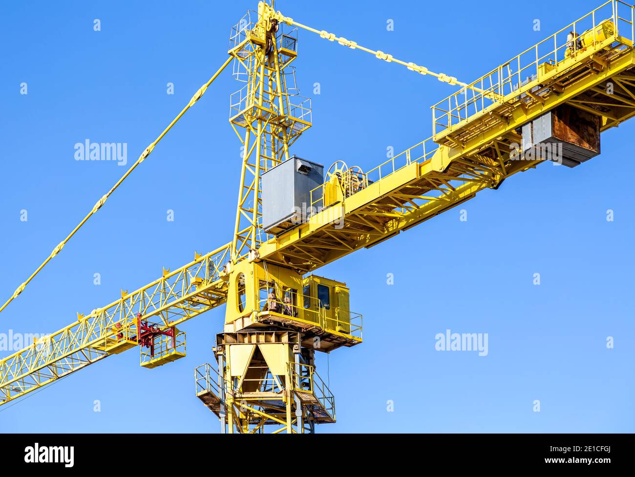 Construction tower crane against the blue sky background Stock Photo