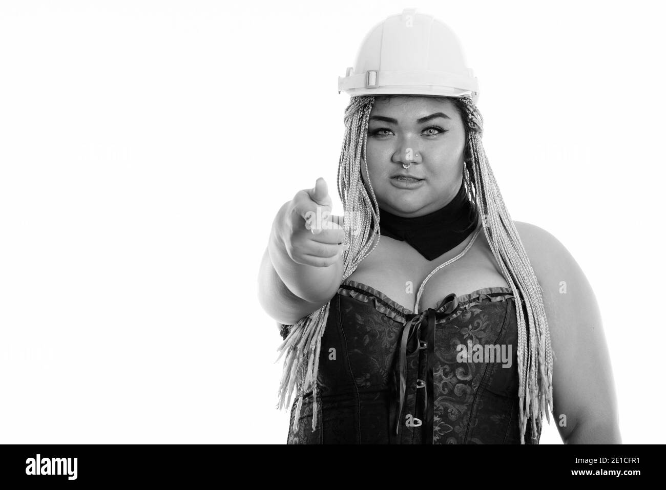 Young fat Asian construction woman pointing at camera Stock Photo
