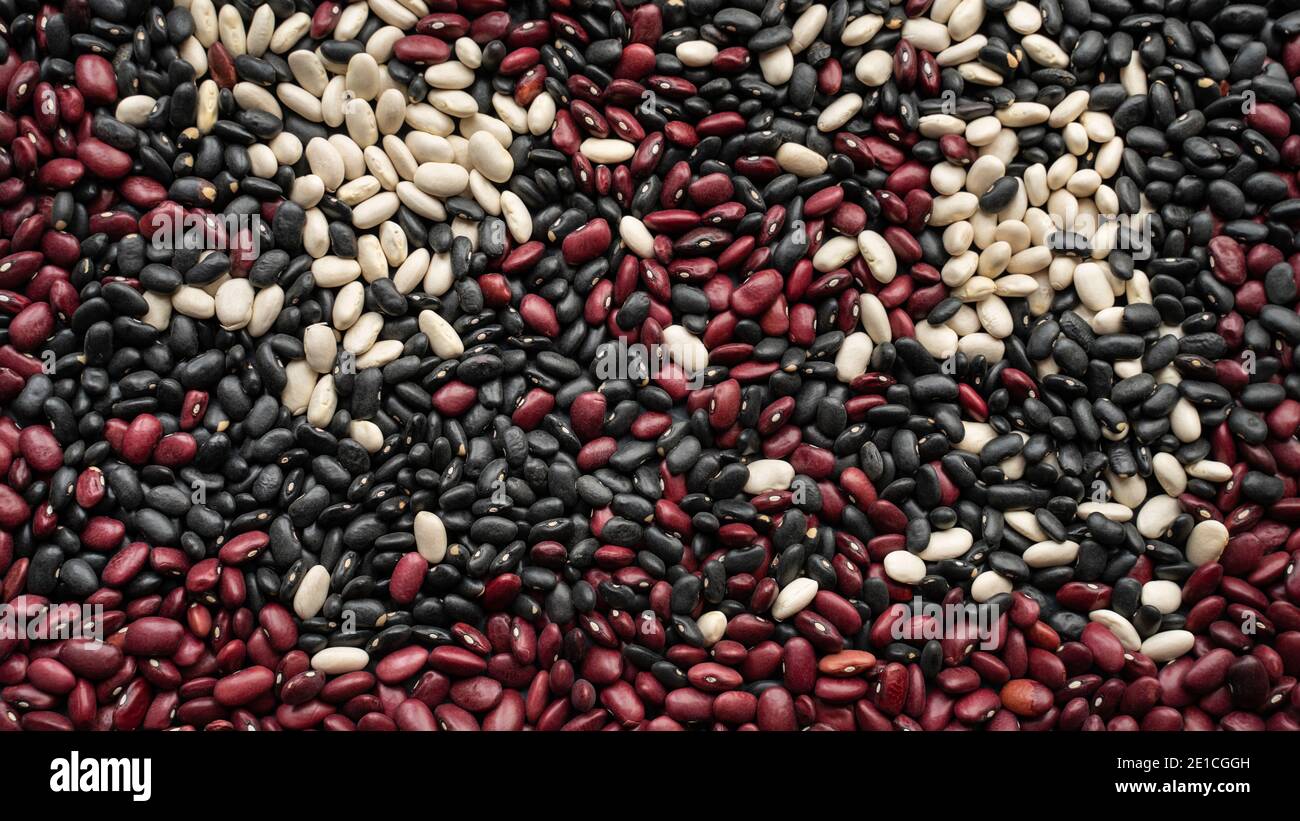 background made from black bean, red kidney bean and white bean. navy bean, cannellini bean, white kidney bean and scattered various beans Stock Photo
