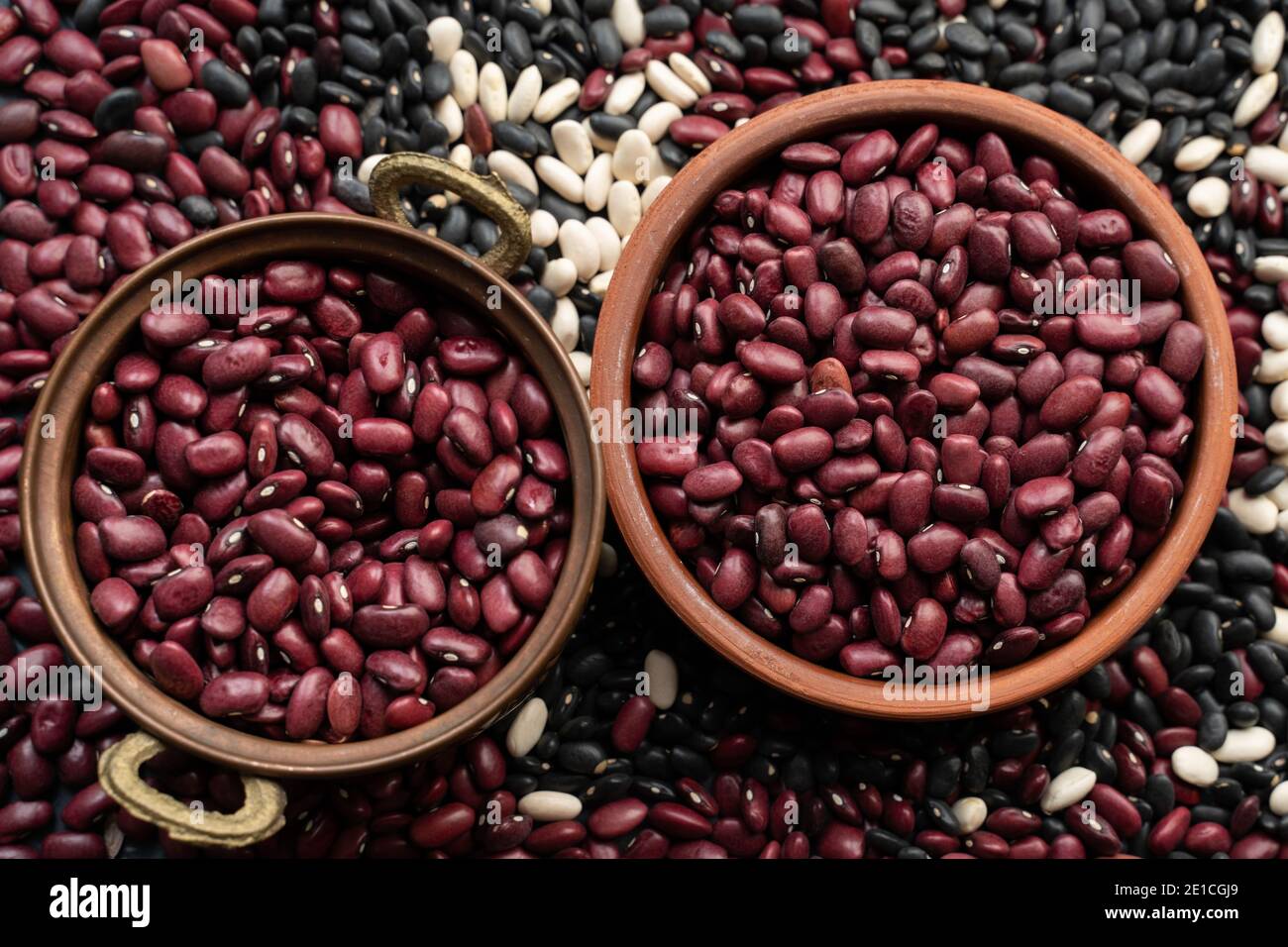 beans in brown ceramic bowl and copper bowl. bowl of beans. black bean