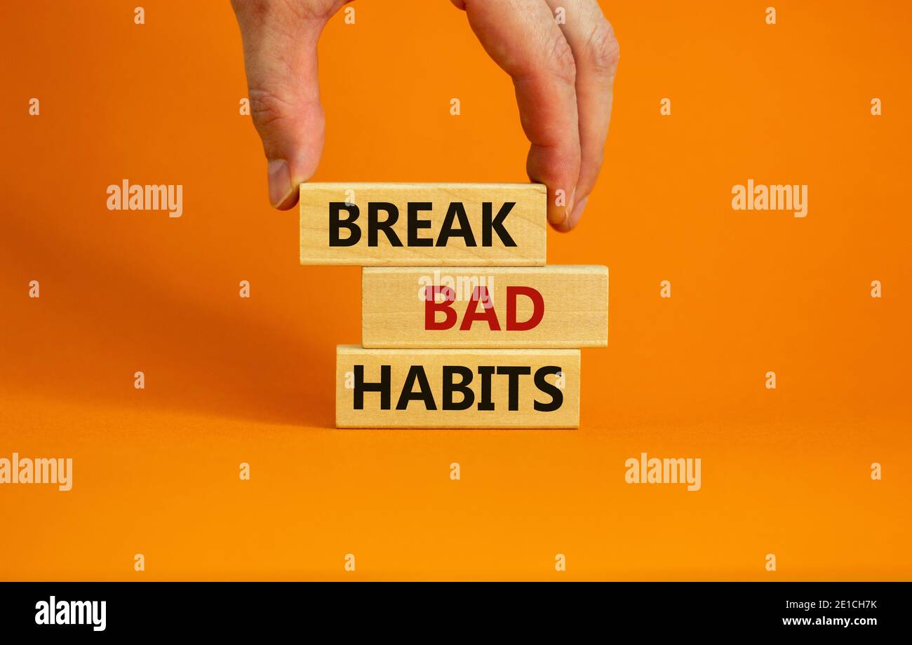 Break bad habits symbol. Wooden blocks with words 'break bad habits ...