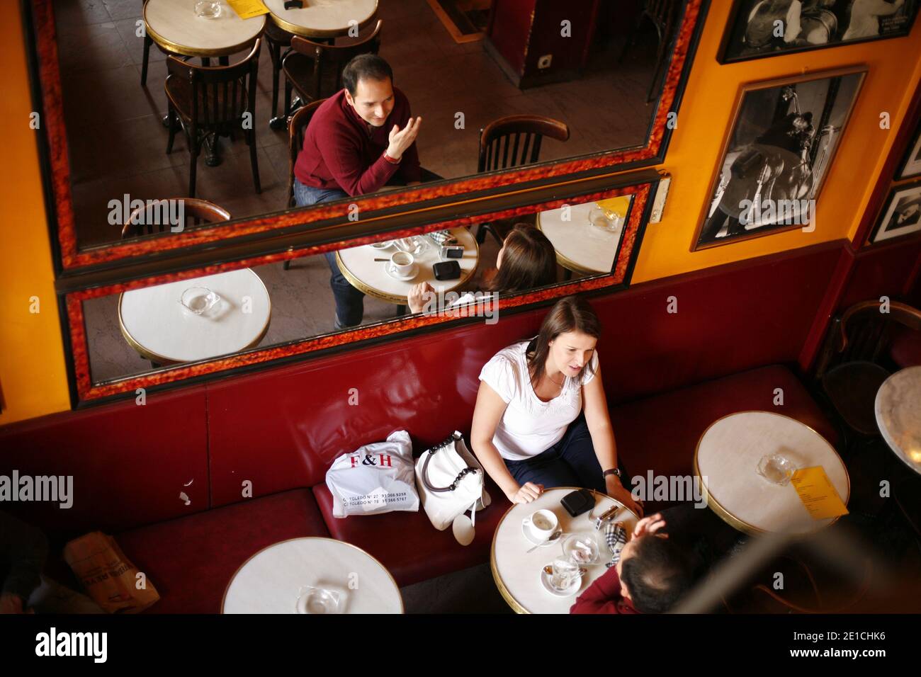 Guests at Cafe del Real in Plaza Isabel II as seen through a mirror. Stock Photo