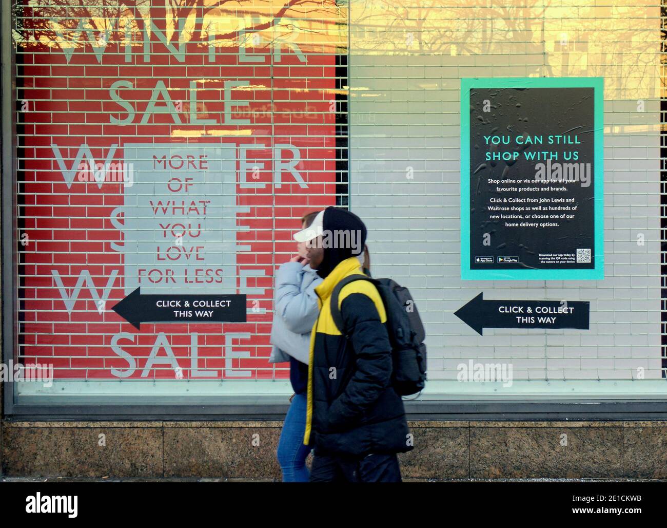 Glasgow, Scotland, UK. 6th January, 2021.  Tier 5 and a total lockdown shown john Lewis click and collect window  saw empty streets in the commercial high streets of the town centre as both people and bushiness became a contributor to the emptiness. People sat alone and were assailed with warning billboards in what is becoming an Orwellian dystopia Credit: Gerard Ferry/Alamy Live News Stock Photo