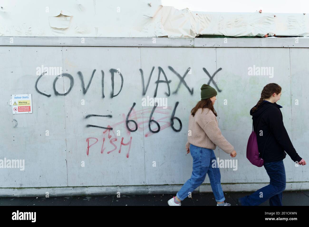 Edinburgh, Scotland, UK. 6 January 2021. Second day of national lockdown and streets fairly busy with members of the public . Much busier than previous national lockdown in 2020. Pic; Anti vaccination graffiti on billboard.  Iain Masterton/Alamy Live News Stock Photo