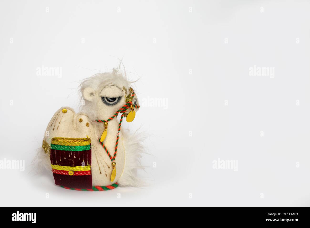 toy camel with colorful blanket on white background Stock Photo