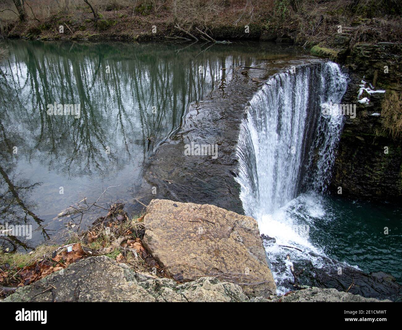 The river flowing over the cliff creating a beautiful waterfall