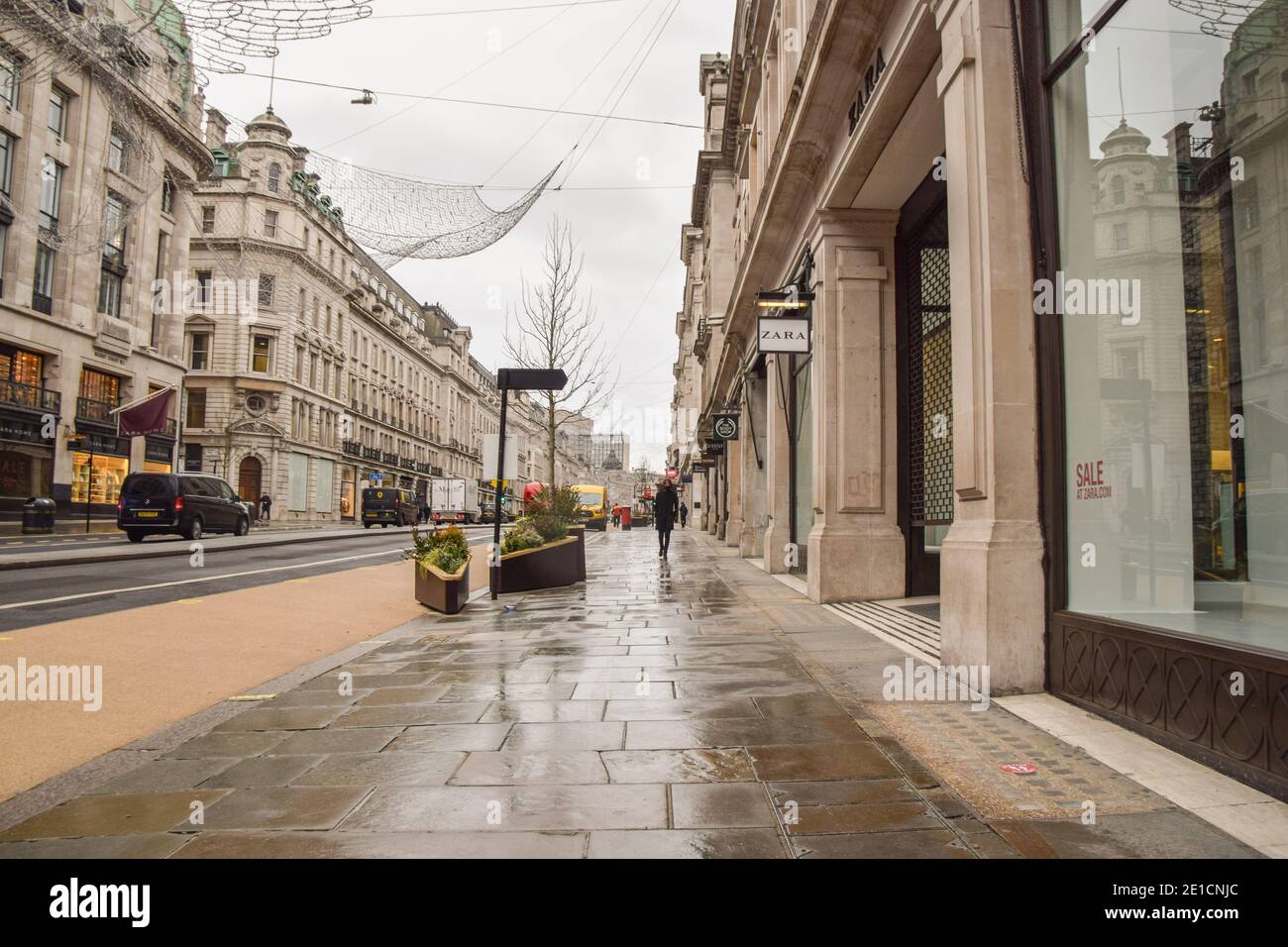 A man walks past closed shops on an empty Regent Street in London, during the third national coronavirus lockdown in England. Stock Photo