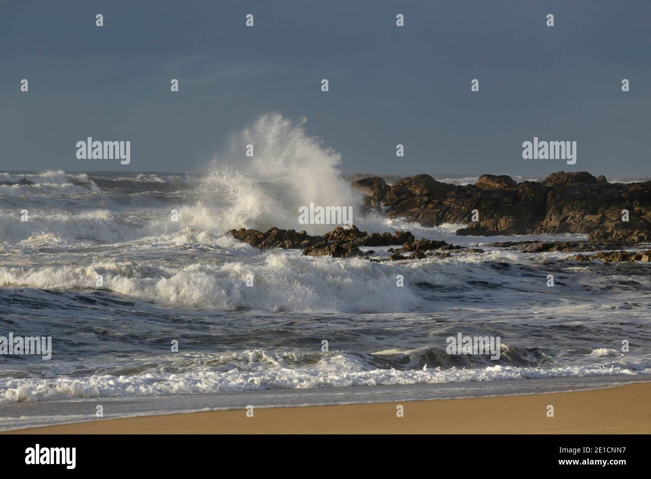 Rocky sea beach during a winter storm Stock Photo