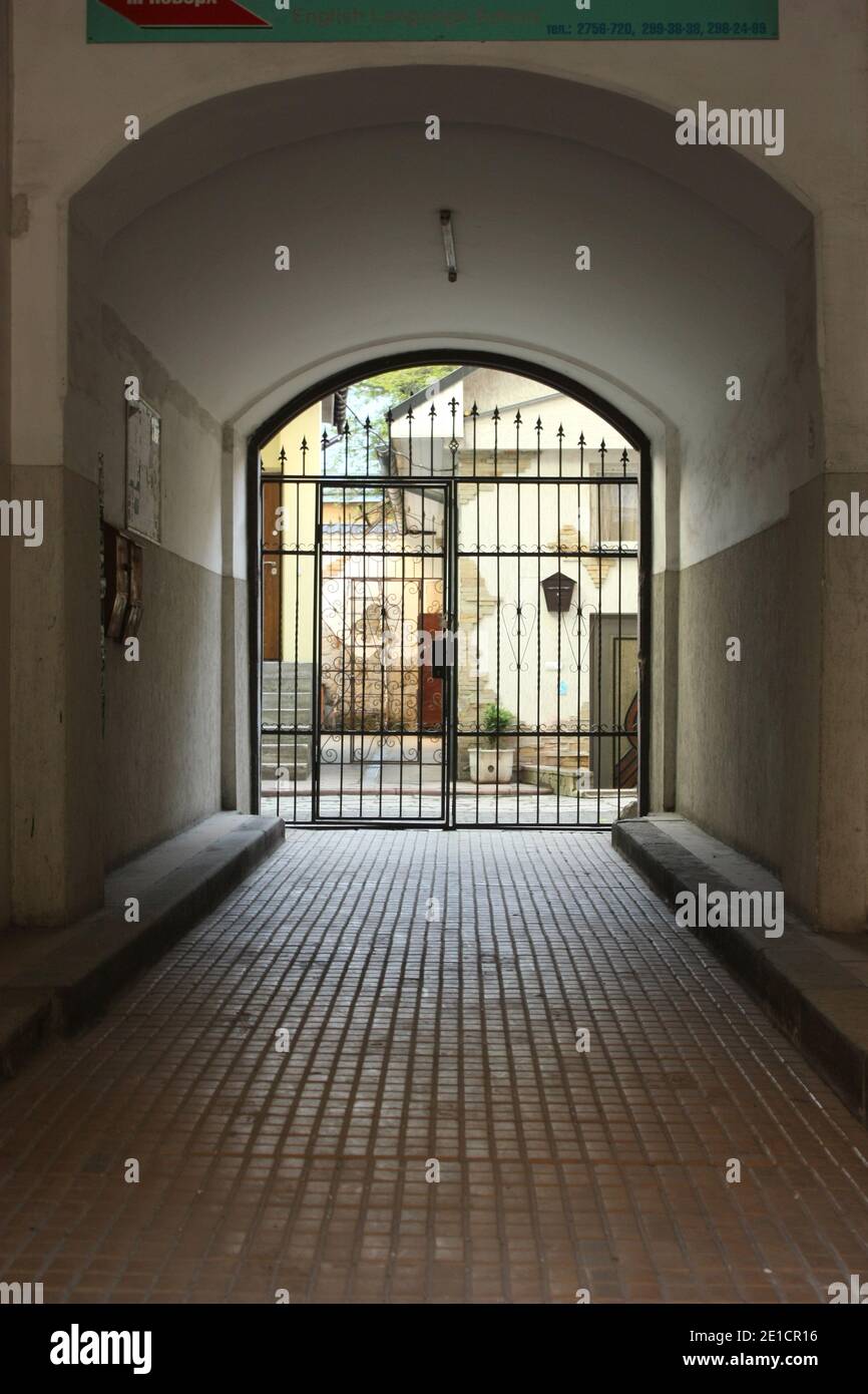 Archway with iron gate in an Ukrainian city Stock Photo