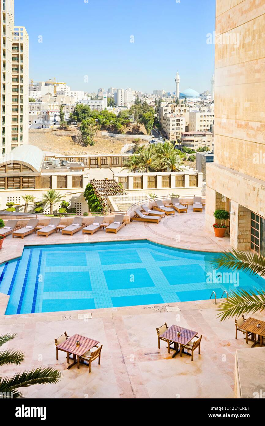 The rooftop pool deck at the Grand Hyatt Amman, Jordan. Chaise lounges