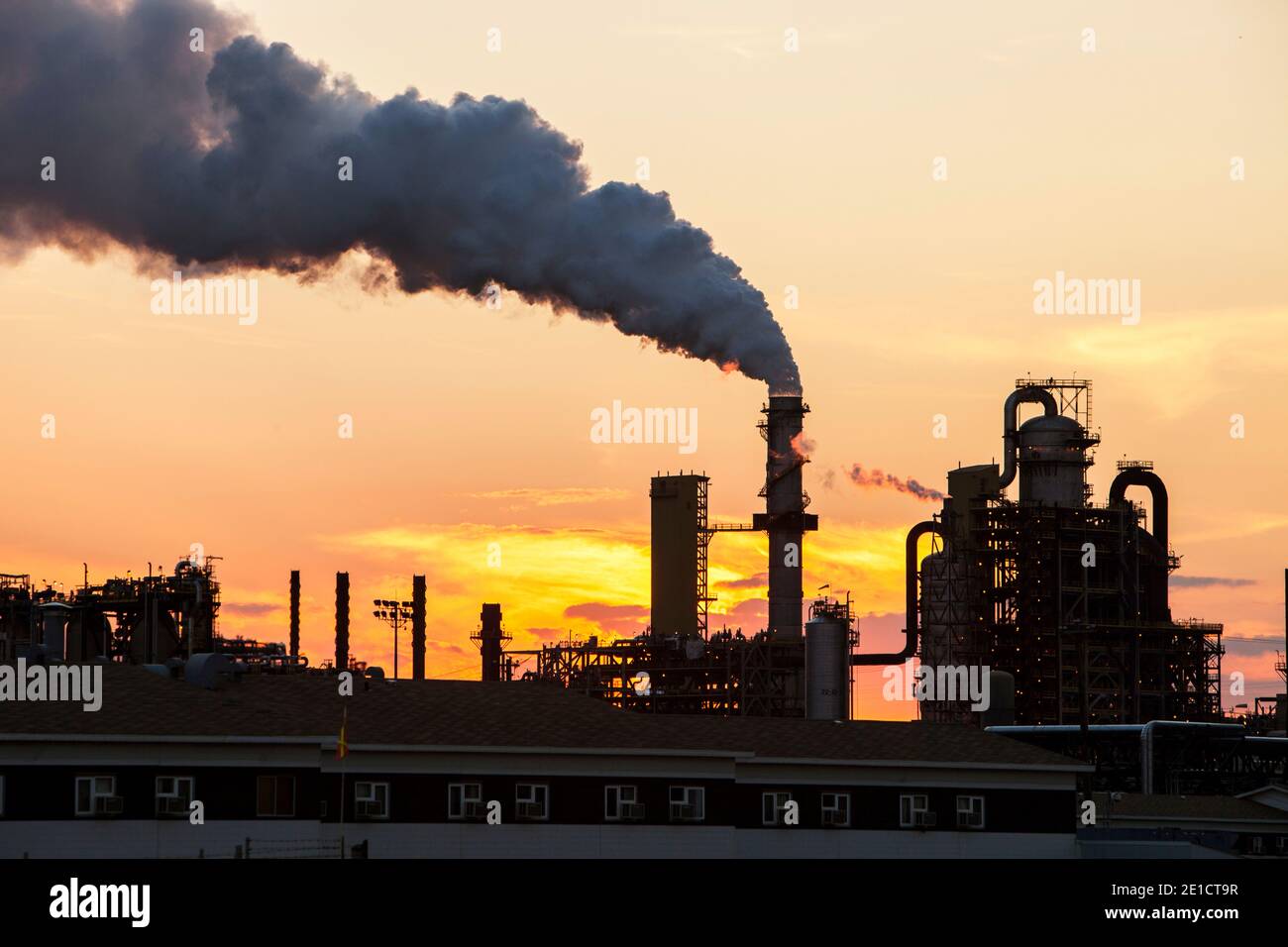 The tar sands upgrader plant at the Syncrude mine north of Fort McMurray, Alberta, Canada, at sunset.. The tar sands are the largest industrial projec Stock Photo
