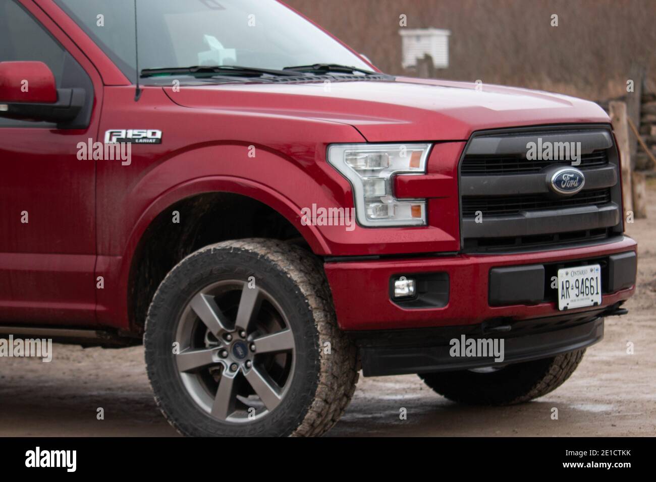 Leamington Canada, January 05 2021: Editorial photograph of a ford F150 with large winter tires that are all muddy from off road driving. Ford f150 is Stock Photo