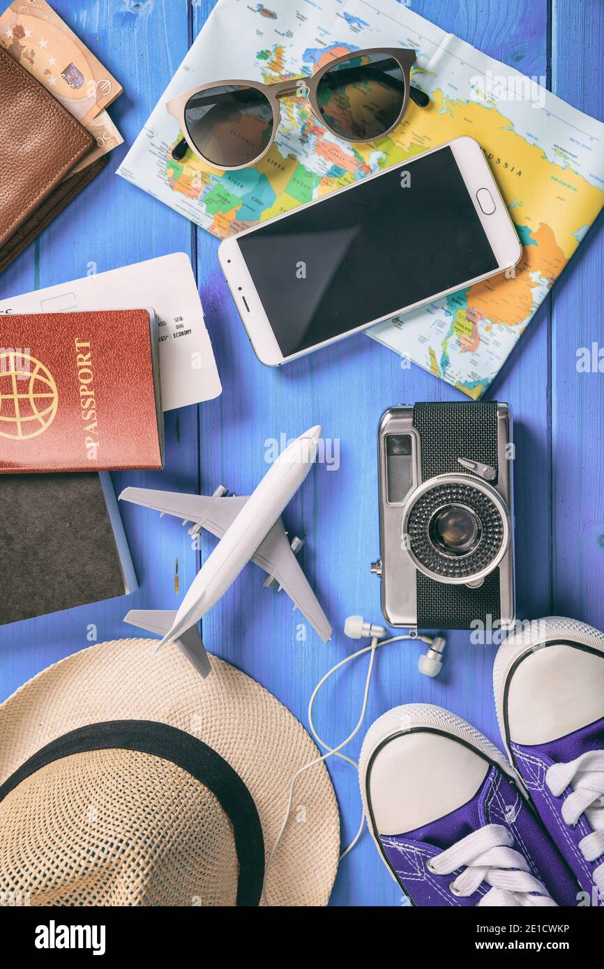 Travel vacation accessories background flat lay. Equipment for summer holidays, passport, tickets, money, mobile, sunglasses, map, camera, hat, sneake Stock Photo
