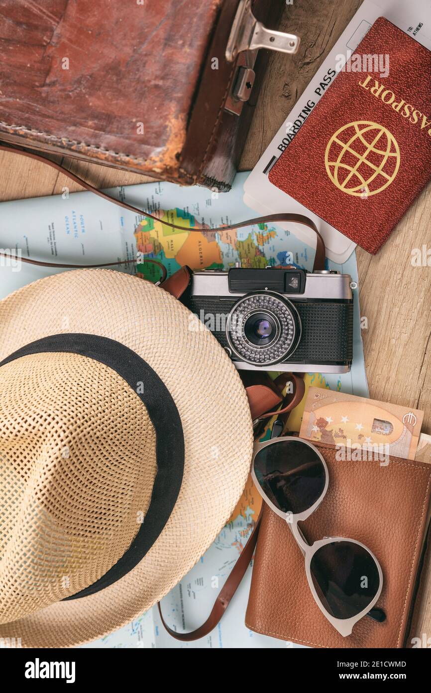 Travel and vacation accessories background. Equipment for summer holidays, passport, tickets, money, sunglasses, map, camera, hat, old leather suitcas Stock Photo