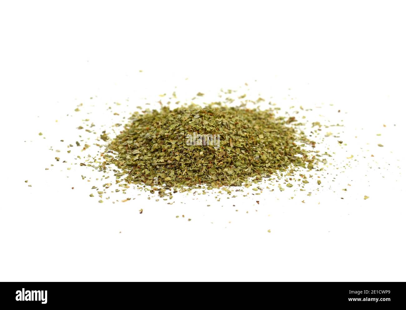 Dry marjoram spice (Origanum majorana). Heap of ground marjoram leaves isolated on white Stock