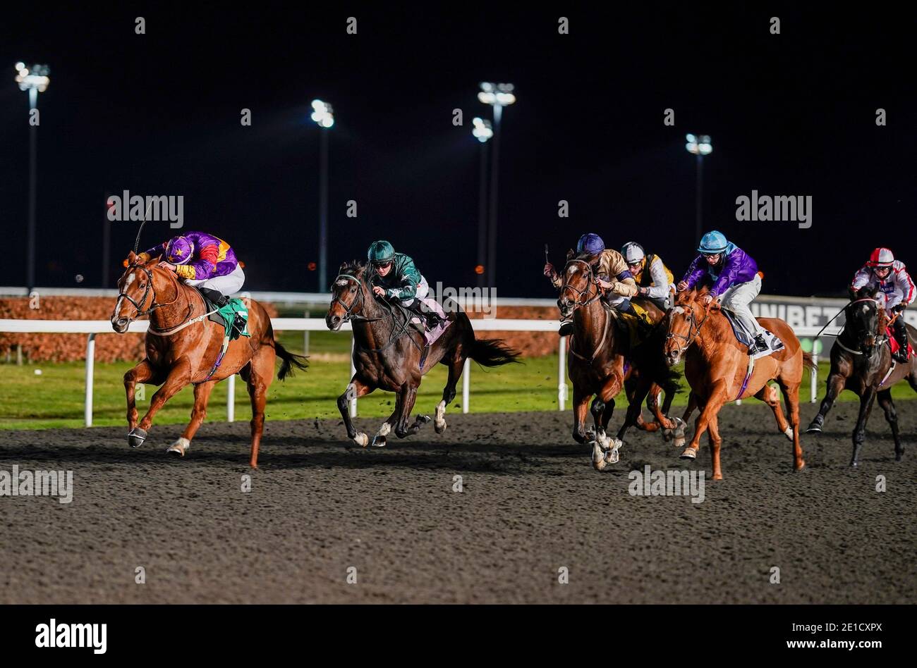 Andrew Breslin riding Lucky Deal (left) winning the Try Our New Super Boosts At Unibet Handicap at Kempton Park Racecourse. Stock Photo